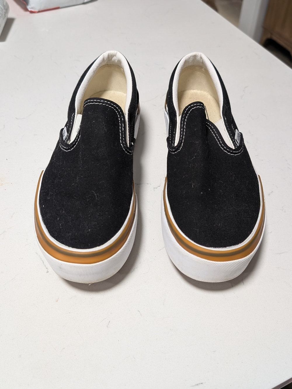 Vans Black Slip-On Canvas Sneakers with Tan Accent